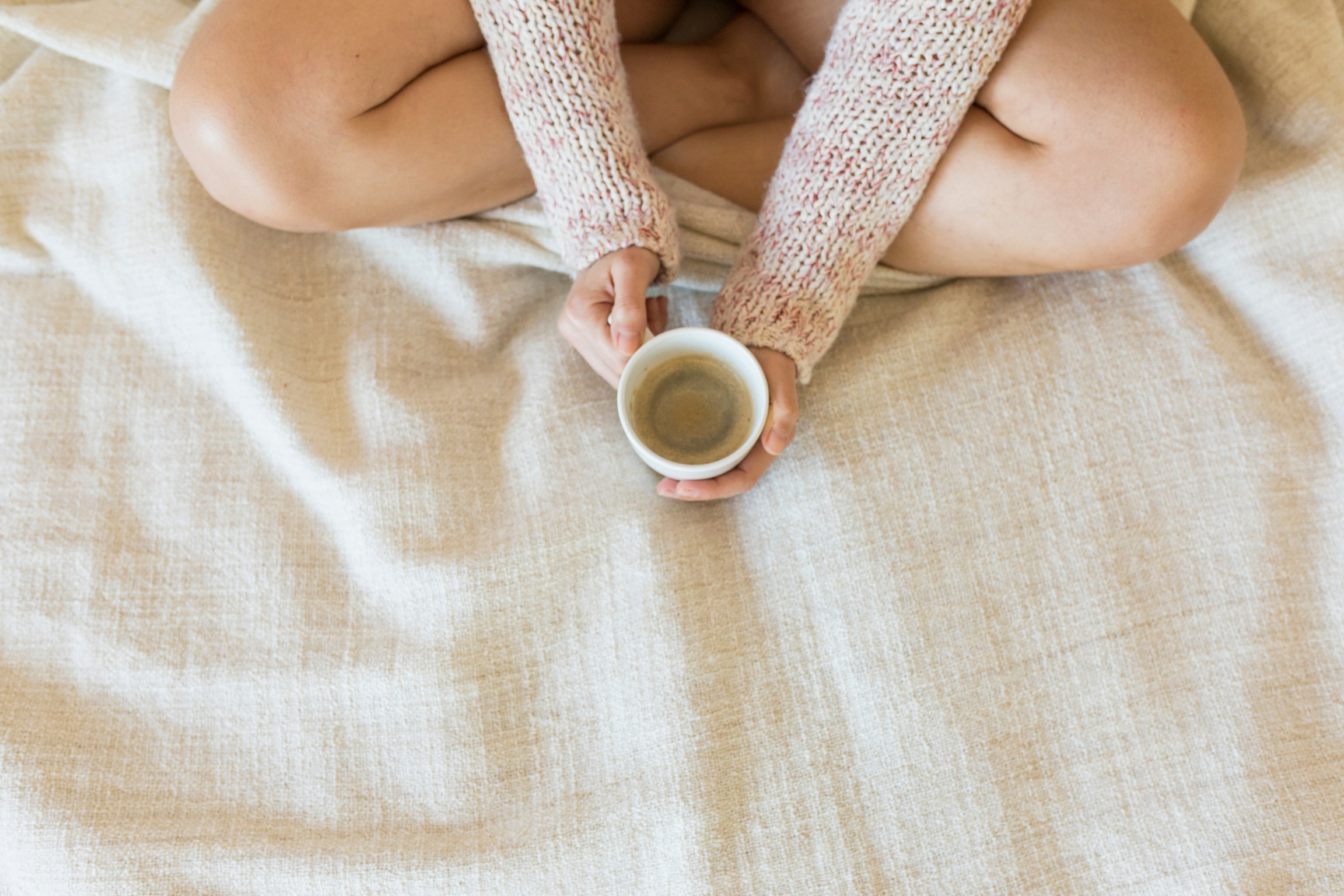 Woman Enjoying Coffee While Sitting in Bed